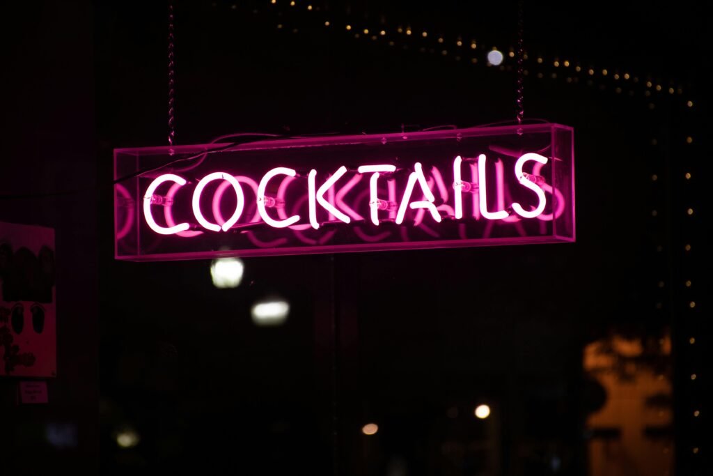 Illuminated neon sign displaying 'cocktails' against a dark background, perfect for nightlife themes.