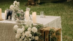 Charming outdoor wedding setup with candles, flowers, and decor.