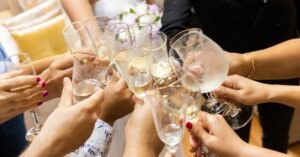 Hands toasting with champagne glasses at a wedding celebration